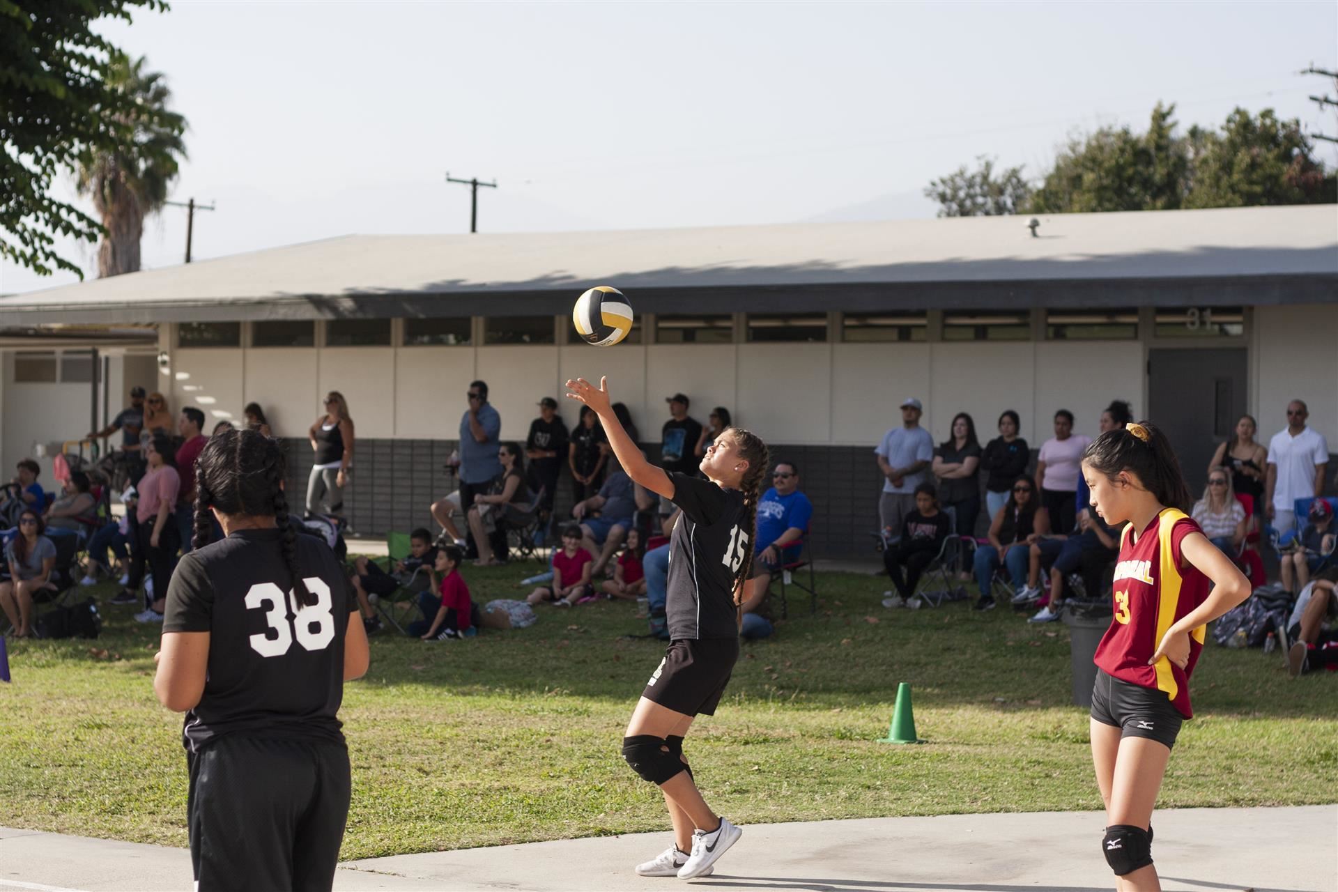 Girl serves volleyball