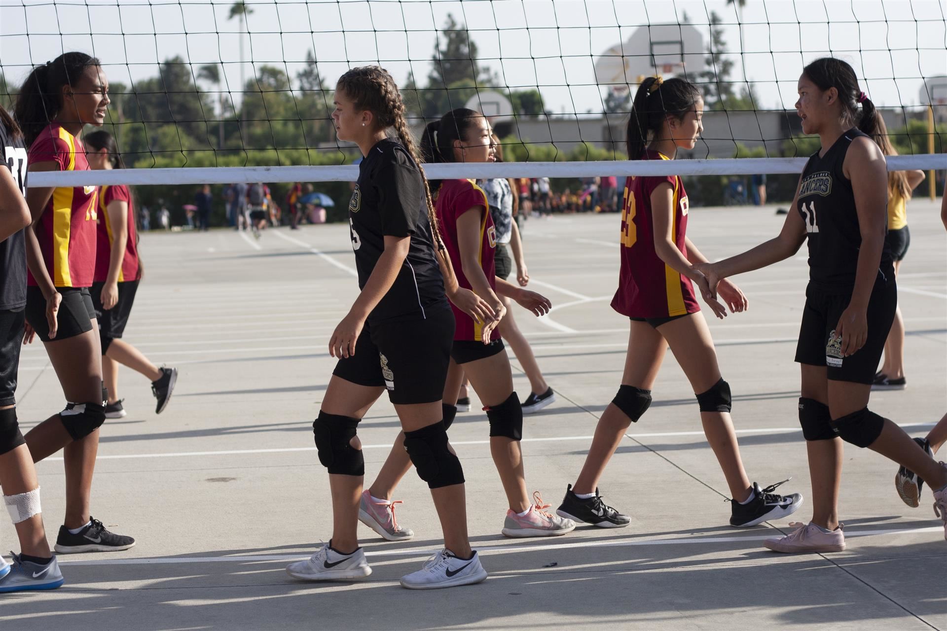 Girls Volleyball players change positions