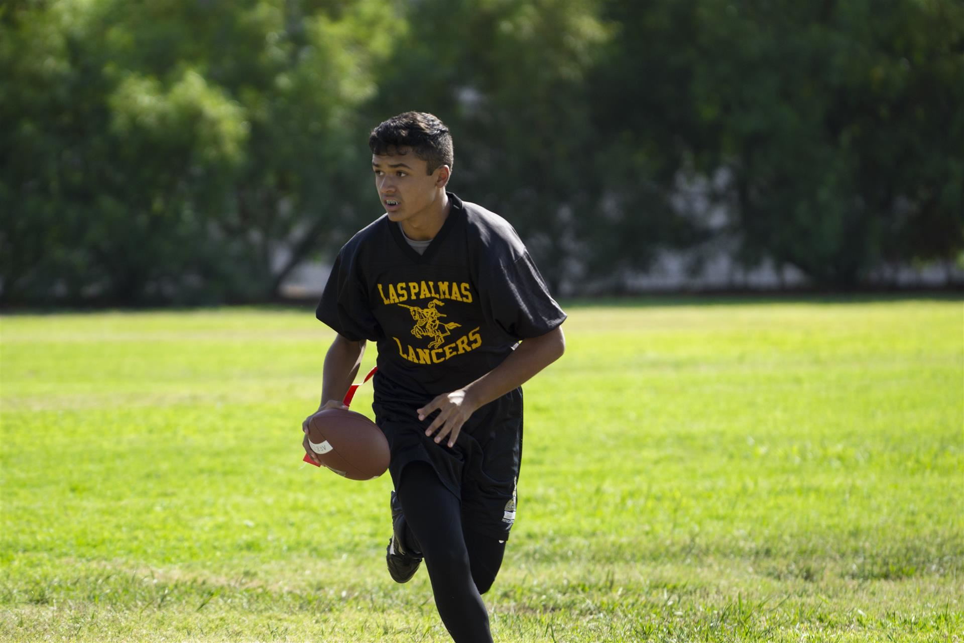 Boy runs with football