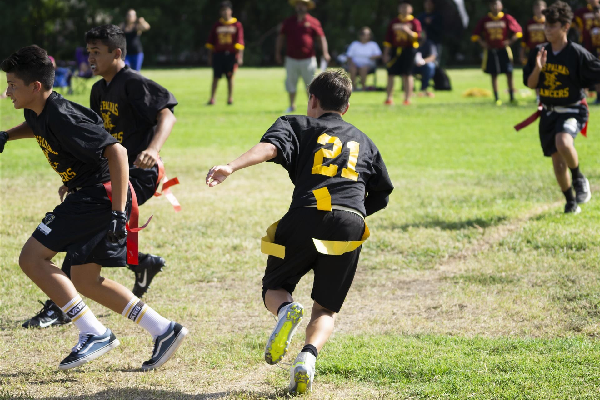 Boys Football players run across field